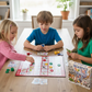 Three children playing a board game called 'Sequence for Kids' at a table - KWtoyszone | Proudly Canadian