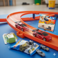 Toy car track set with cars and packaging on a blue surface - KWtoyszone | Proudly Canadian
