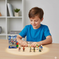 Child playing with toy figures on a table in a room with shelves in the background